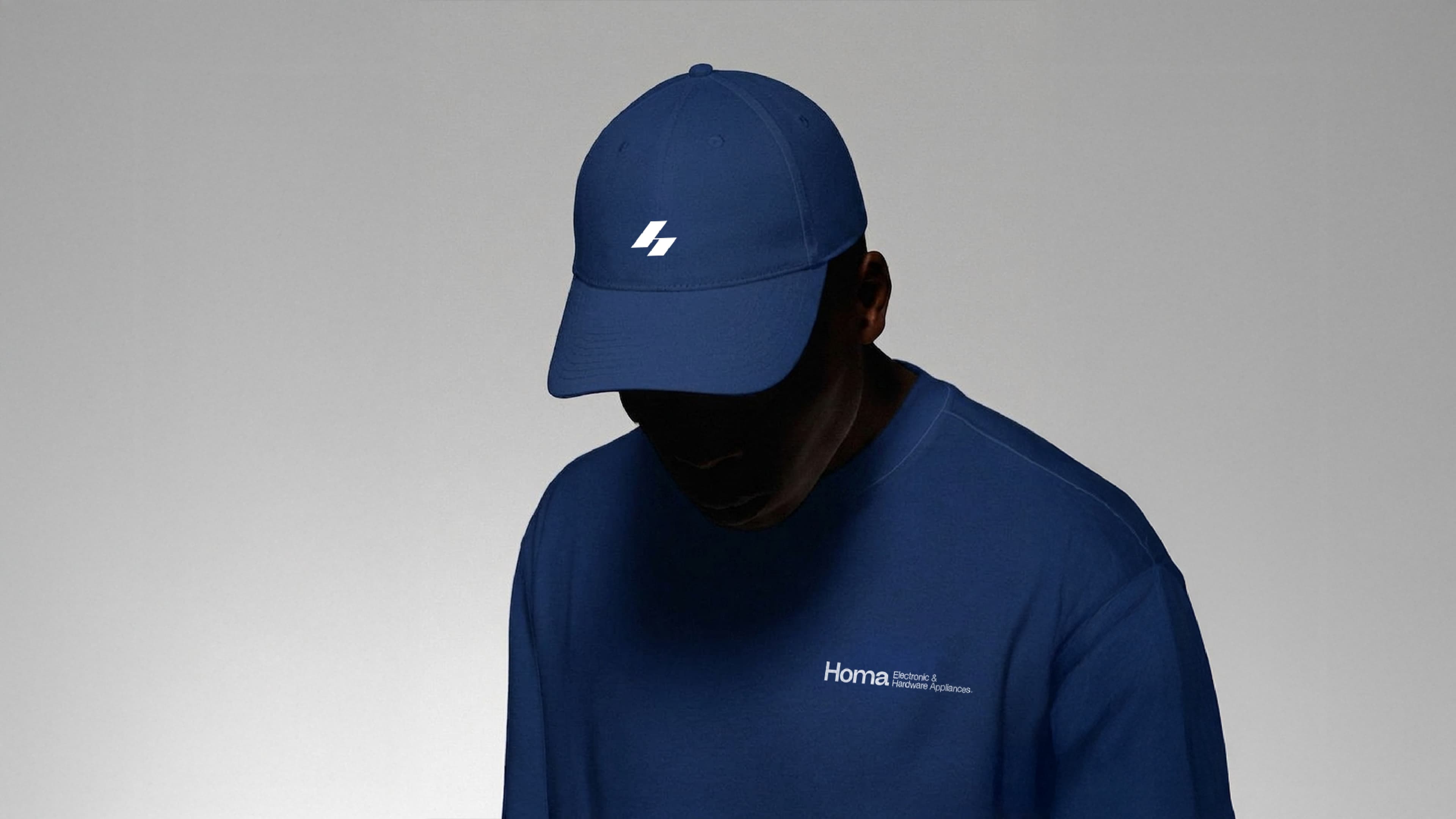 Person wearing a blue Homa cap and T-shirt