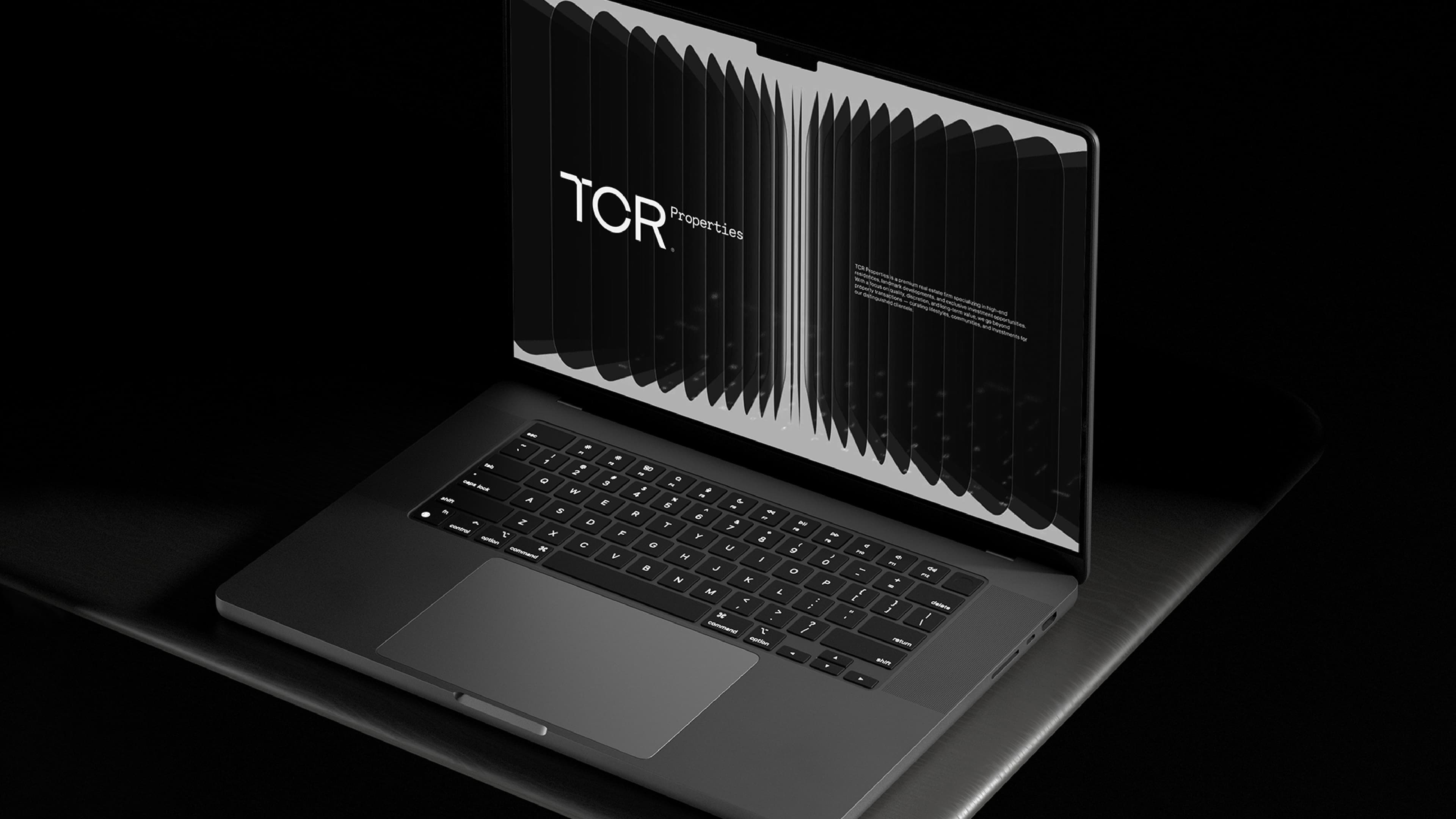 TCR Properties branding on a laptop