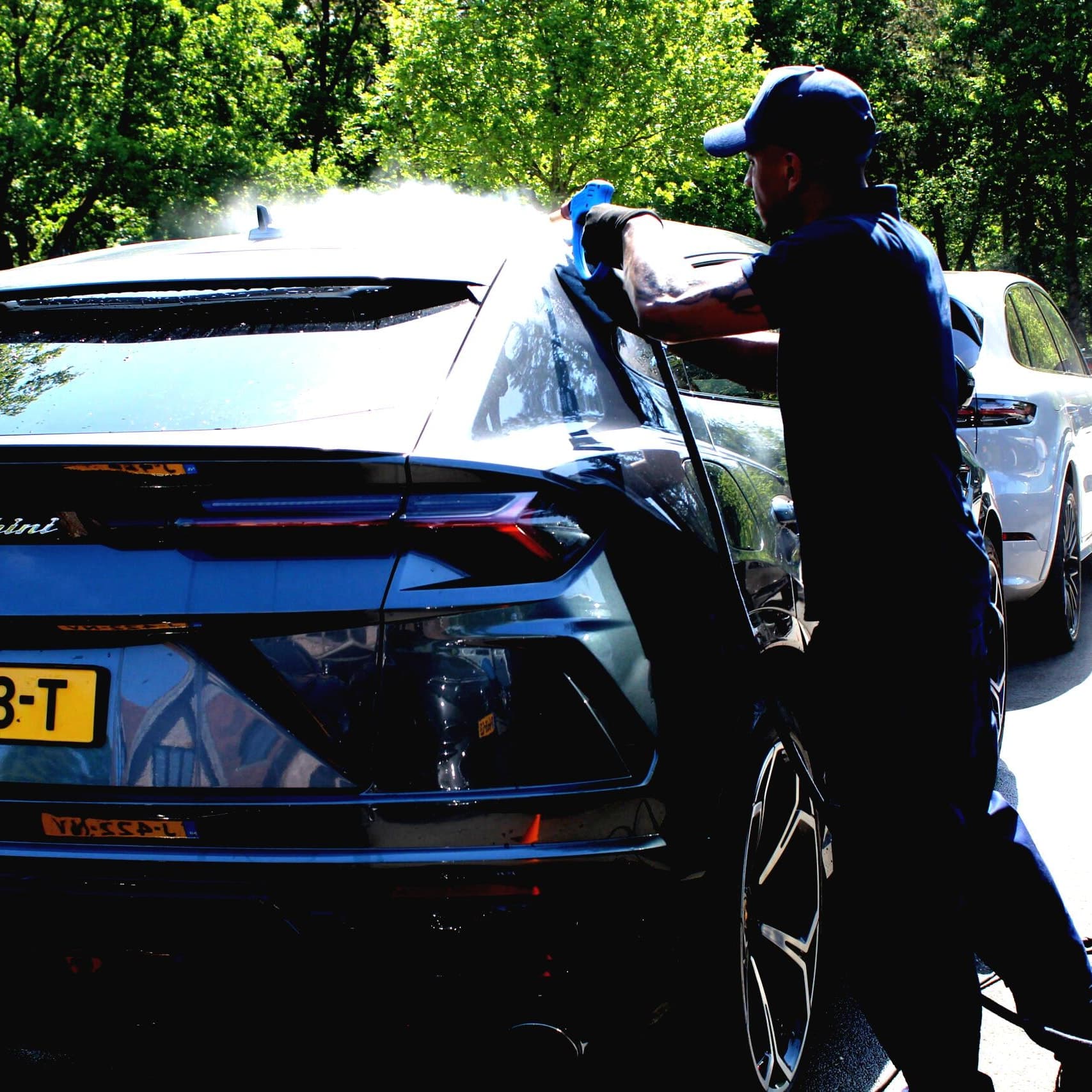 Fast Clean technician steam cleaning an SUV